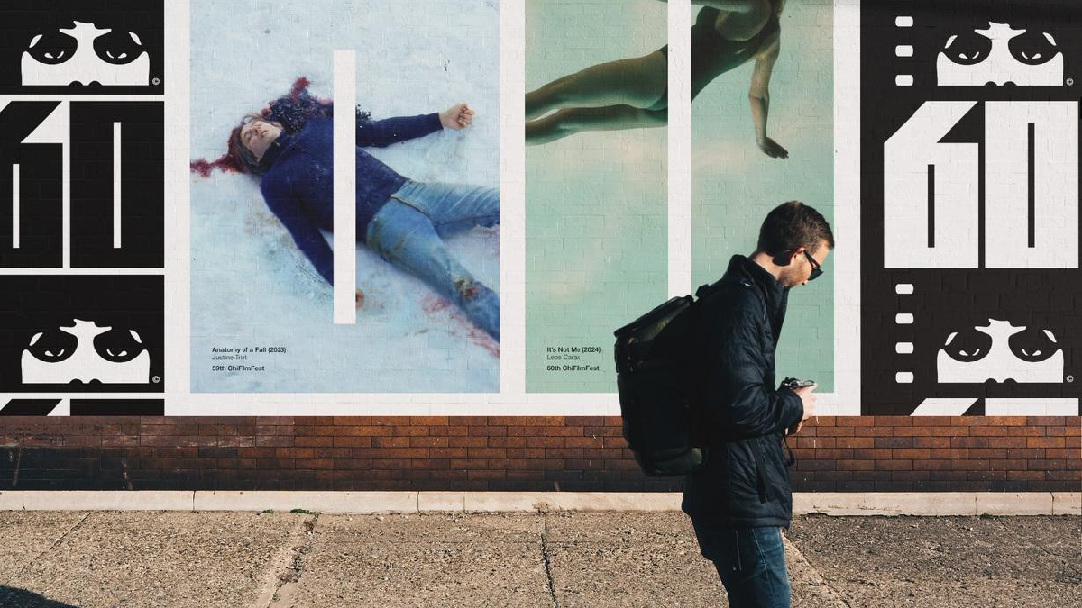 Pedestrian walking past a large outdoor mural featuring Chicago International Film Festival posters celebrating 60 years of cinema.