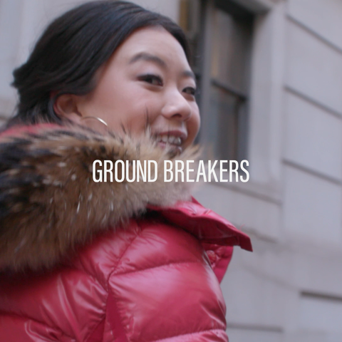 Person wearing a red winter jacket smiling outdoors with the words ‘Ground Breakers’ overlaid.