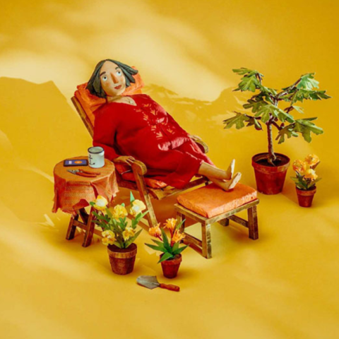 Claymation-style character sitting outside a small tent with camping gear on a minimalist green background.