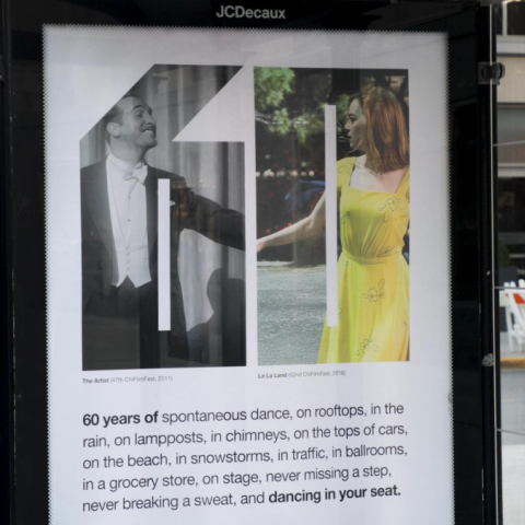 Street-level view of a Chicago International Film Festival 60th anniversary poster displayed in a JCDecaux bus shelter, showcasing paired film scenes within a custom ‘60’ visual system.