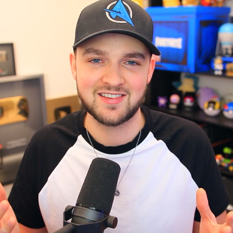 Gaming content creator presenting and speaking into a microphone while discussing Sky Gigafast broadband and the in-game speedrun experience.