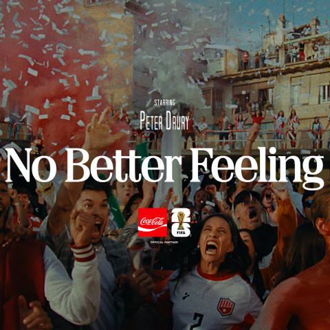 "Title card for Coca-Cola's FIFA World Cup campaign 'No Better Feeling', starring Peter Drury. A jubilant crowd of football fans celebrating with confetti filling the air, set against an outdoor urban backdrop. The Coca-Cola and FIFA World Cup Official Partner logos are displayed beneath the title."