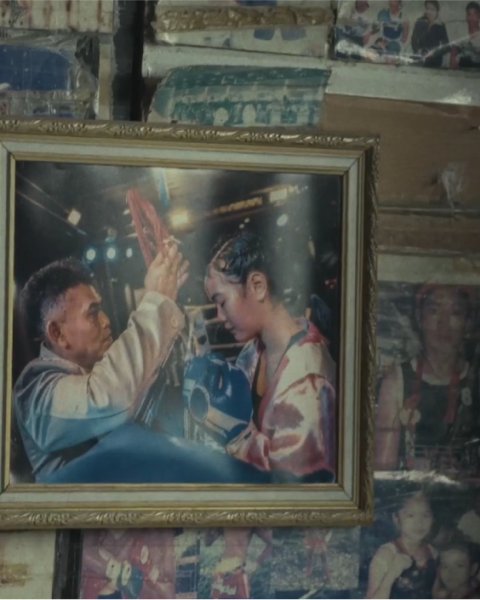 Picture frame on the wall showing a female boxer champion.