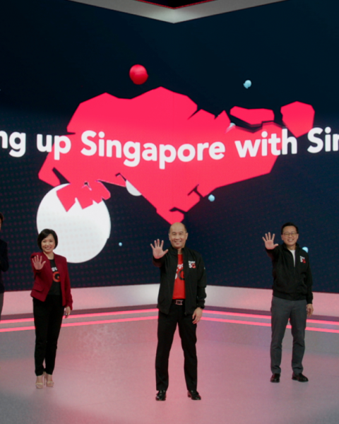 A collection of five individuals each holding their hand up.