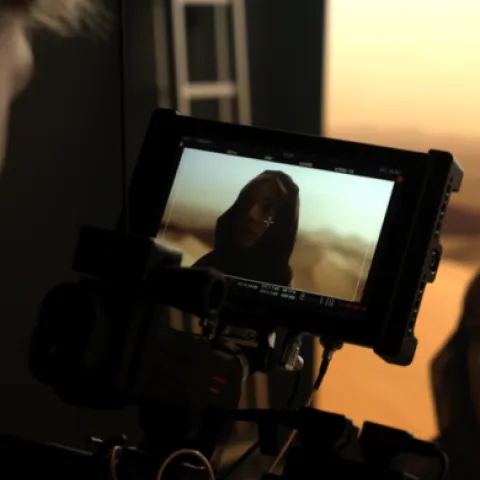 a camera shot of a woman in a desert in a virtual production background